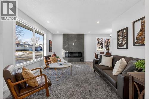 203 Lynnover Place Se, Calgary, AB - Indoor Photo Showing Living Room With Fireplace