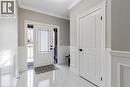 Foyer with crown molding, light marble finish flooring, a wainscoted wall, and a decorative wall - 24 Tamarack Way, Simcoe, ON  - Indoor Photo Showing Other Room 