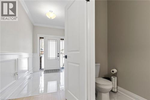 Bathroom with crown molding, wainscoting, and a decorative wall - 24 Tamarack Way, Simcoe, ON - Indoor Photo Showing Bathroom