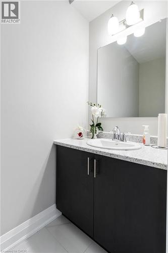 Bathroom featuring vanity and light tile patterned flooring - 24 Tamarack Way, Simcoe, ON - Indoor Photo Showing Bathroom