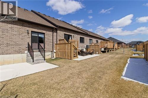 Rear view of property with a patio area, brick siding, a residential view, and roof with shingles - 24 Tamarack Way, Simcoe, ON - Outdoor