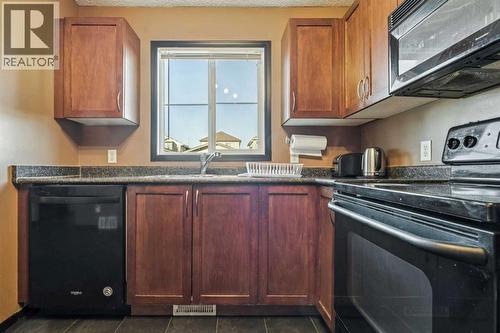 110 Eversyde Common Sw, Calgary, AB - Indoor Photo Showing Kitchen With Double Sink