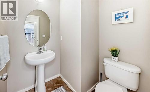 2 piece bath close to the back entrance - 822 Panatella Boulevard Nw, Calgary, AB - Indoor Photo Showing Bathroom