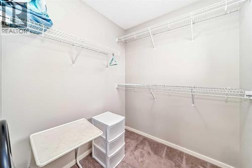 walk in closet - 822 Panatella Boulevard Nw, Calgary, AB - Indoor With Storage