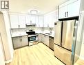 7616 27 Street Se, Calgary, AB  - Indoor Photo Showing Kitchen With Stainless Steel Kitchen With Double Sink 
