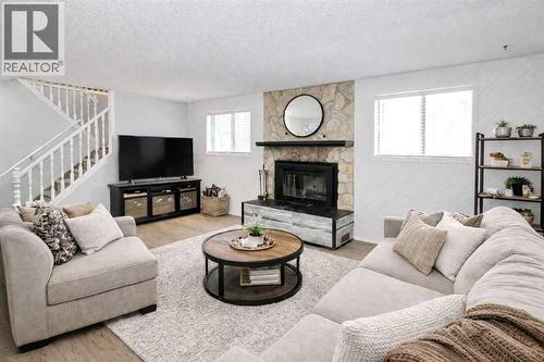 virtually staged - 97 Cunningham Crescent, Red Deer, AB - Indoor Photo Showing Living Room With Fireplace