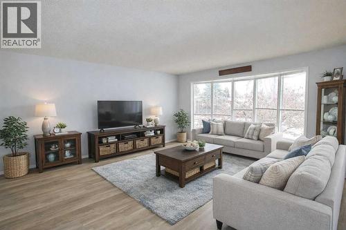 virtually staged - 97 Cunningham Crescent, Red Deer, AB - Indoor Photo Showing Living Room