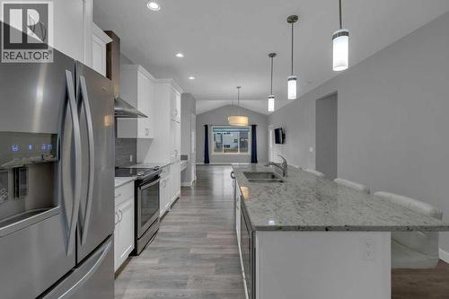 Kitchen with stainless steel appliances - 137 Willow Park N, Cochrane, AB - Indoor Photo Showing Kitchen With Stainless Steel Kitchen With Double Sink With Upgraded Kitchen