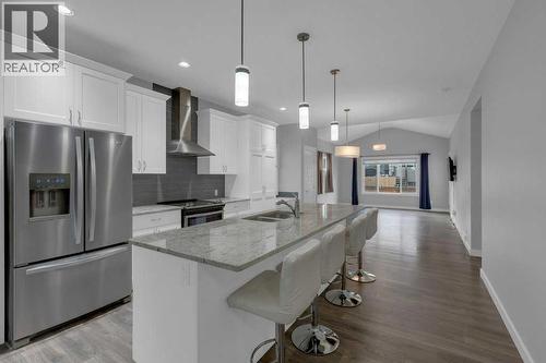 Kitchen with granite countertops - 137 Willow Park N, Cochrane, AB - Indoor Photo Showing Kitchen With Stainless Steel Kitchen With Double Sink With Upgraded Kitchen