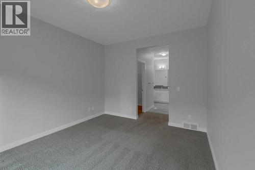 Primary bedroom access to ensuite - 137 Willow Park N, Cochrane, AB - Indoor Photo Showing Other Room