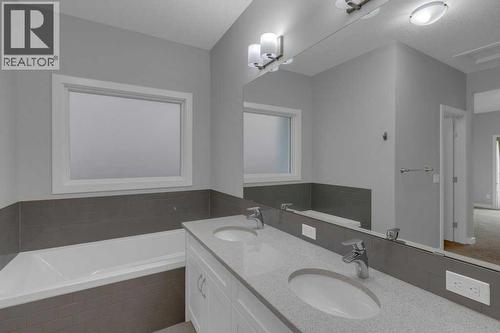 Ensuite sleek granite countertops - 137 Willow Park N, Cochrane, AB - Indoor Photo Showing Bathroom