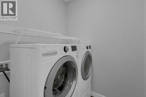 Convenient main floor laundry - 137 Willow Park N, Cochrane, AB - Indoor Photo Showing Laundry Room