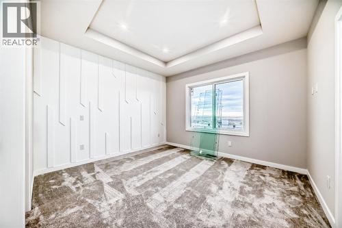 Primary bedroom with Tray ceiling - 508 Heritage Boulevard, Cochrane, AB - Indoor Photo Showing Other Room