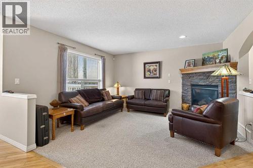 Living Room - 627 Auburn Bay Heights Se, Calgary, AB - Indoor Photo Showing Living Room With Fireplace