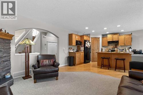 Living Room and Kitchen - 627 Auburn Bay Heights Se, Calgary, AB - Indoor With Fireplace