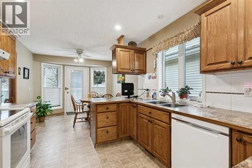 1025 Shawnee Road Sw, Calgary, AB - Indoor Photo Showing Kitchen With Double Sink