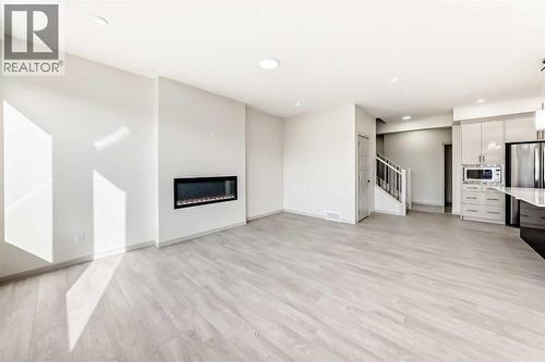 31 Lucas Passage Nw, Calgary, AB - Indoor With Fireplace