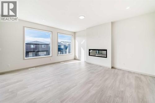 31 Lucas Passage Nw, Calgary, AB - Indoor Photo Showing Living Room With Fireplace