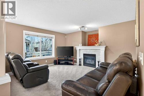 69 Elkton Way Sw, Calgary, AB - Indoor Photo Showing Living Room With Fireplace