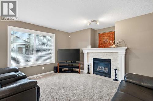 69 Elkton Way Sw, Calgary, AB - Indoor Photo Showing Living Room With Fireplace
