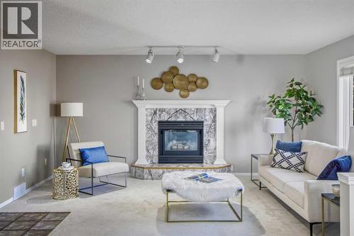 134 Hamptons Heath Nw, Calgary, AB - Indoor Photo Showing Living Room With Fireplace
