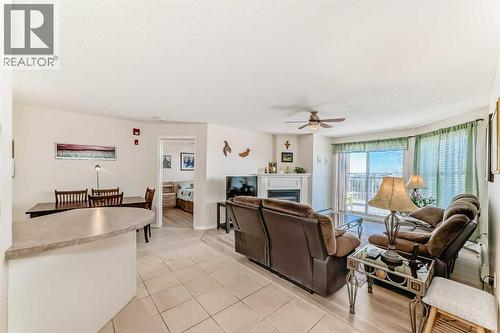 111, 6900 Hunterview Drive Nw, Calgary, AB - Indoor Photo Showing Living Room With Fireplace