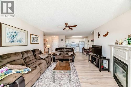 111, 6900 Hunterview Drive Nw, Calgary, AB - Indoor Photo Showing Living Room With Fireplace