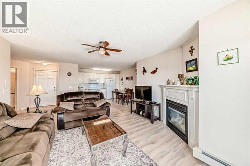 111, 6900 Hunterview Drive Nw, Calgary, AB - Indoor Photo Showing Living Room With Fireplace