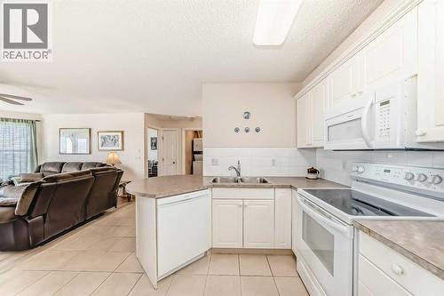 111, 6900 Hunterview Drive Nw, Calgary, AB - Indoor Photo Showing Kitchen With Double Sink