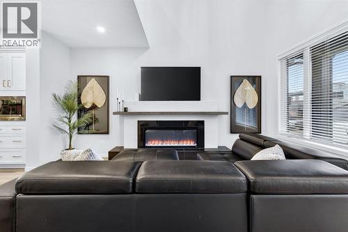 413 Belmont Park Sw, Calgary, AB - Indoor Photo Showing Living Room With Fireplace
