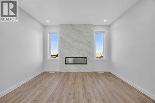 26 Versant Path Sw, Calgary, AB - Indoor Photo Showing Living Room With Fireplace
