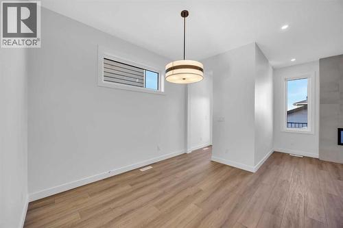 14 Versant Path Sw, Calgary, AB - Indoor Photo Showing Other Room With Fireplace