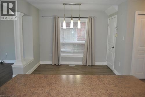Unfurnished dining area with ornate columns and dark wood-style floors - 154 Harding Street, Kitchener, ON - Indoor Photo Showing Other Room