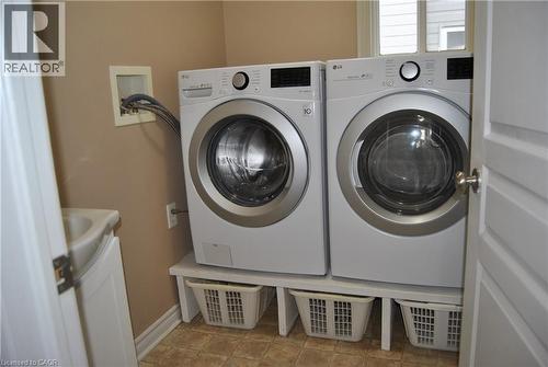 Washroom with separate washer and dryer and baseboards - 154 Harding Street, Kitchener, ON - Indoor Photo Showing Laundry Room