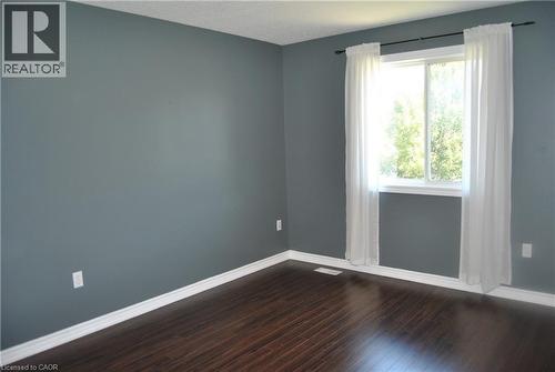 Unfurnished room featuring dark wood finished floors and baseboards - 154 Harding Street, Kitchener, ON - Indoor Photo Showing Other Room