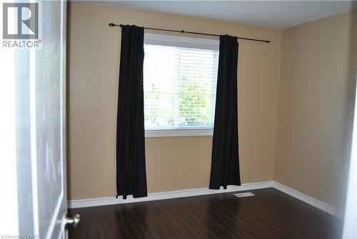 Spare room with baseboards and dark wood-style flooring - 154 Harding Street, Kitchener, ON - Indoor Photo Showing Other Room
