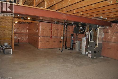 Unfinished basement featuring heating unit, a water softener, and gas water heater - 154 Harding Street, Kitchener, ON - Indoor Photo Showing Basement