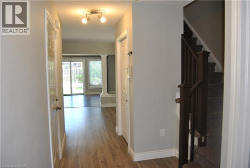 Hallway with dark wood finished floors, stairway, and ornate columns - 154 Harding Street, Kitchener, ON - Indoor Photo Showing Other Room