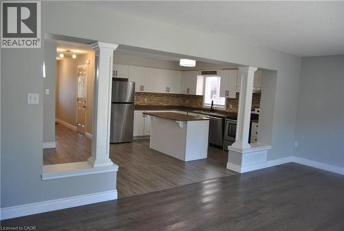 Kitchen featuring ornate columns, dark countertops, and appliances with stainless steel finishes - 154 Harding Street, Kitchener, ON - Indoor Photo Showing Kitchen