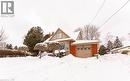 View of front of property featuring an attached garage, a chimney, and brick siding - 854 West 5Th Street, Hamilton, ON  - Outdoor 