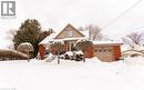 View of front facade with a garage, brick siding, and a chimney - 854 West 5Th Street, Hamilton, ON  - Outdoor 