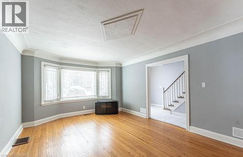 Spare room featuring stairs, visible vents, baseboards, and wood finished floors - 854 West 5Th Street, Hamilton, ON - Indoor Photo Showing Other Room