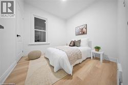 Bedroom featuring light wood finished floors and baseboards - 