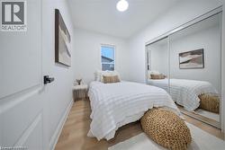 Bedroom featuring wood finished floors and a closet - 