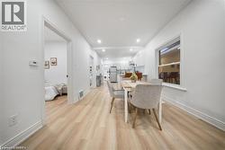 Dining room featuring light wood-style flooring and recessed lighting - 