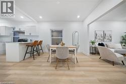 Dining room with light wood finished floors and recessed lighting - 