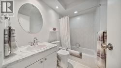 Full bathroom with vanity, shower / bath combo, recessed lighting, and tile patterned flooring - 