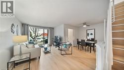 Living room with light wood-style floors and a textured ceiling - 