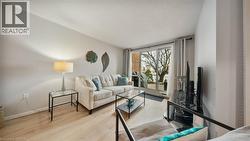 Living area featuring light wood-style floors and baseboards - 