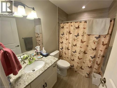 Full bath with vanity, dark wood finished floors, a shower with shower curtain, and a chandelier - 36 Mckenna Court, Hamilton, ON - Indoor Photo Showing Bathroom